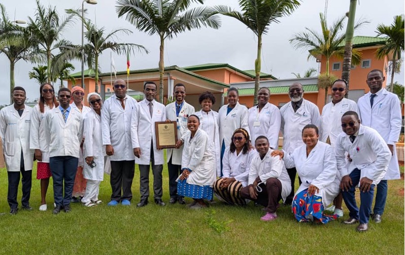 MICEI Consultants and Ophthalmology Residents holding a plaque outside a hospital.