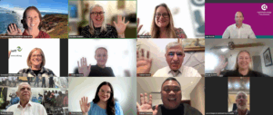 A photo from a zoom. meeting with people waiving at their camera.