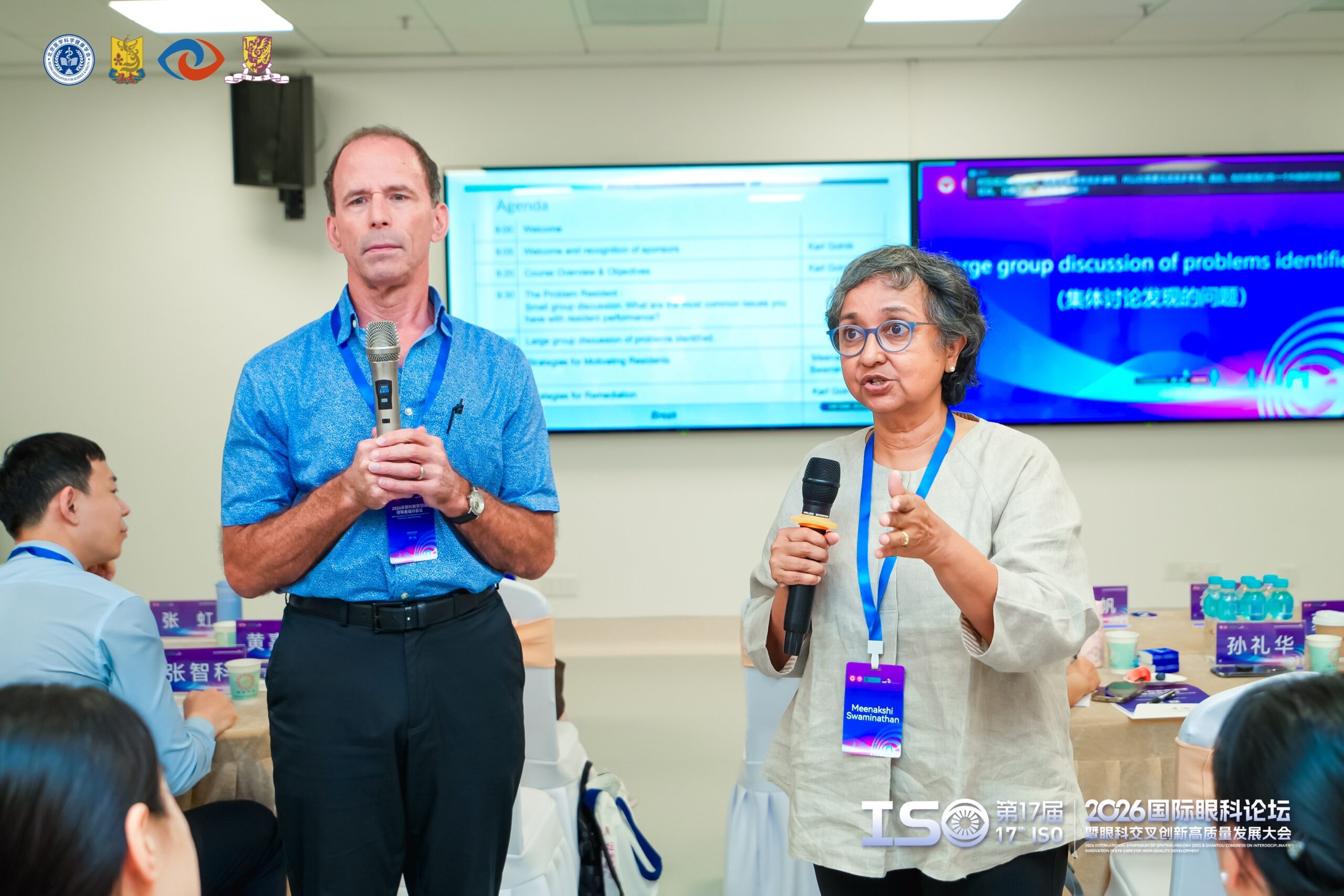 Two ophthalmology teaching professionals in a conference room in China.